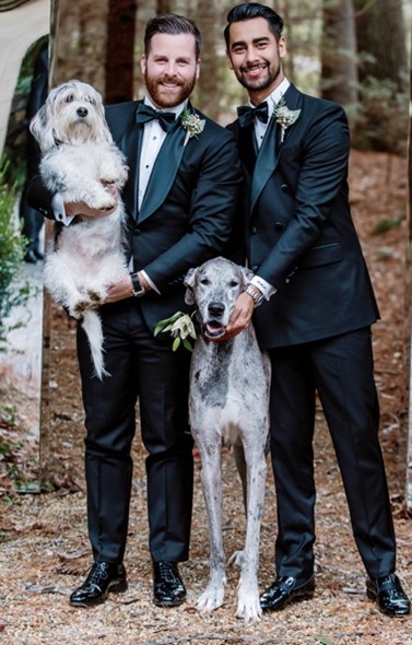 Matt Roden poses with husband and dogs
