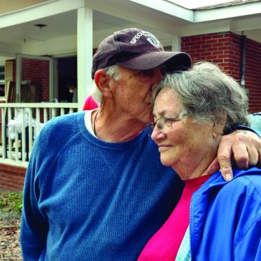 man comforts woman after disaster